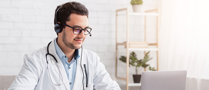 A smiling male doctor wearing a stethoscope around his neck.headset and glasses with a ste